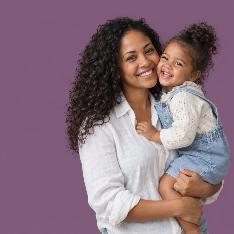 Smiling mother holding her laughing toddler on her hip